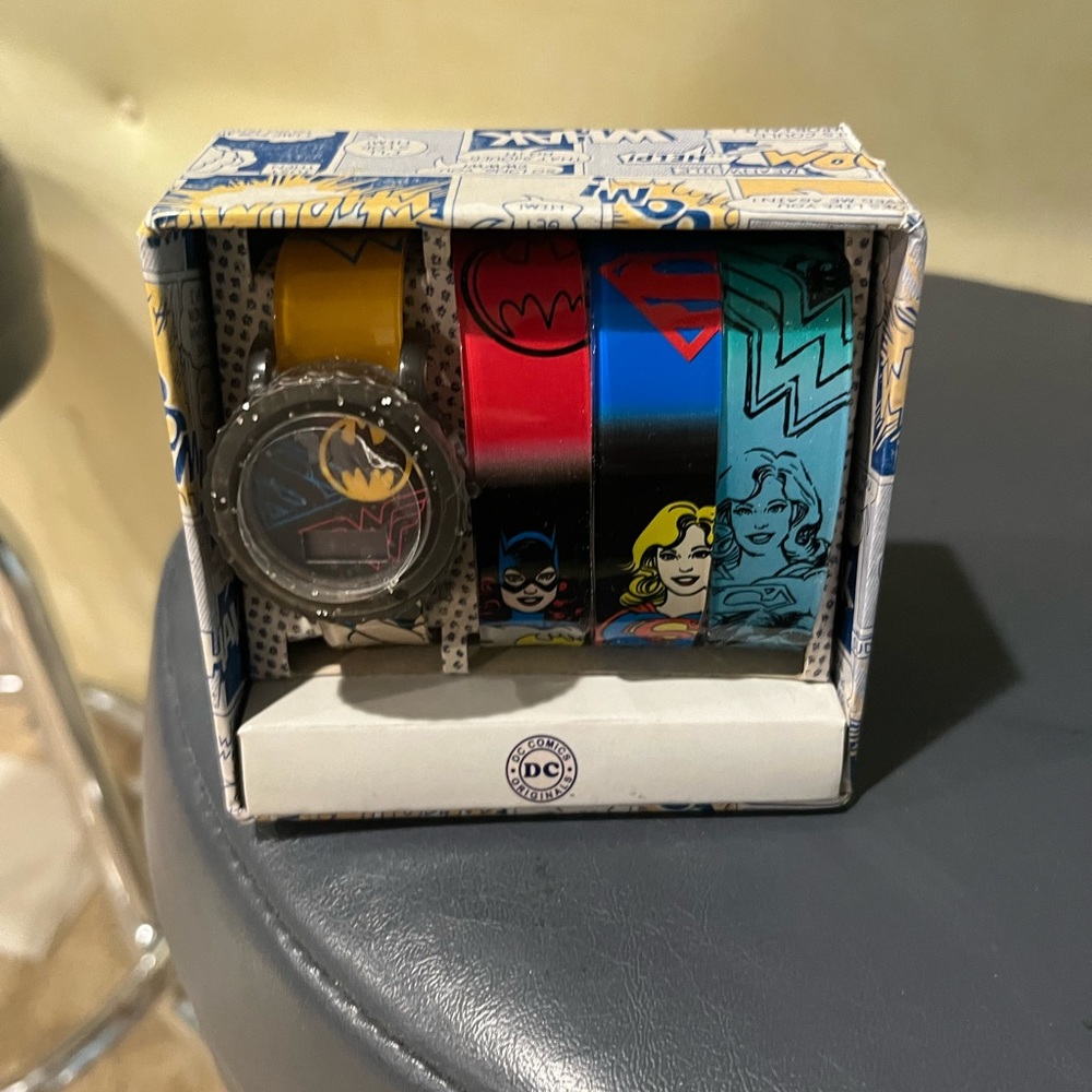 New in sealed box watch with 3 superhero bands including Wonder Woman & Batgirl!